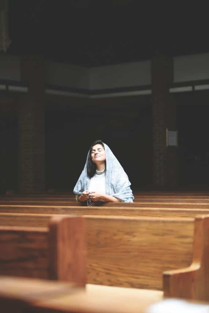 Woman praying rosary