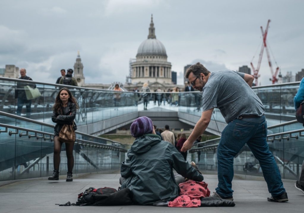 Man offering help to a homeless person