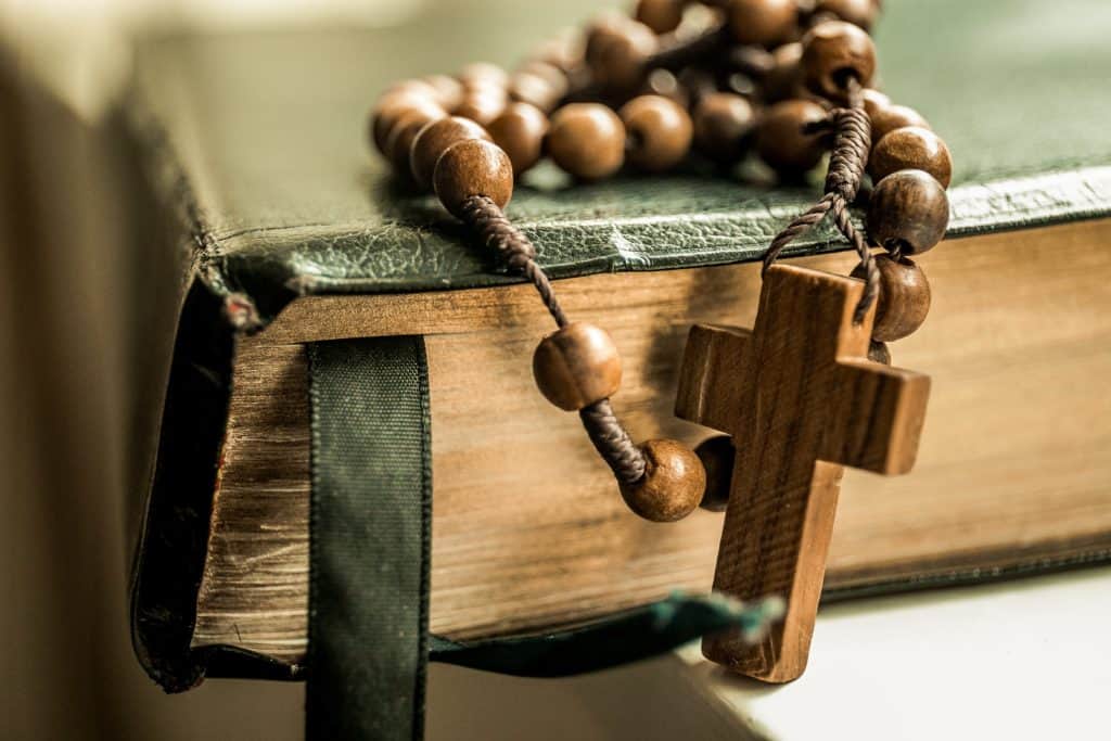 wooden rosary on a bible